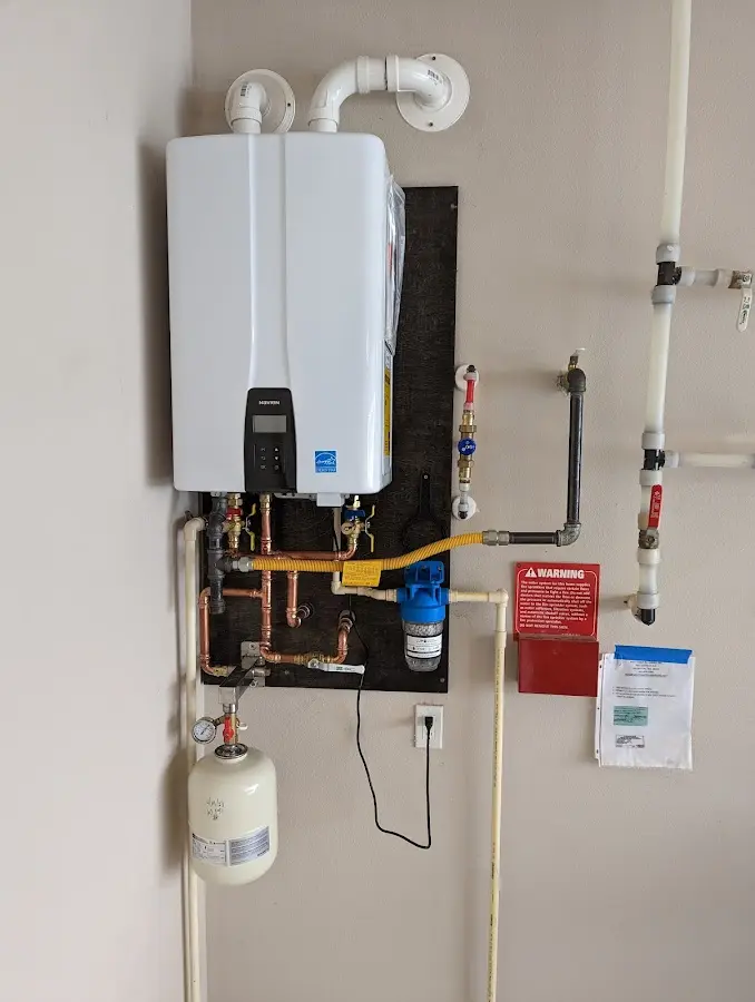 Professional plumber installing copper piping in a West Slope home